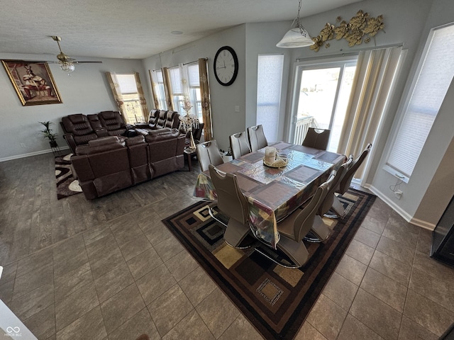 tiled dining area featuring a textured ceiling