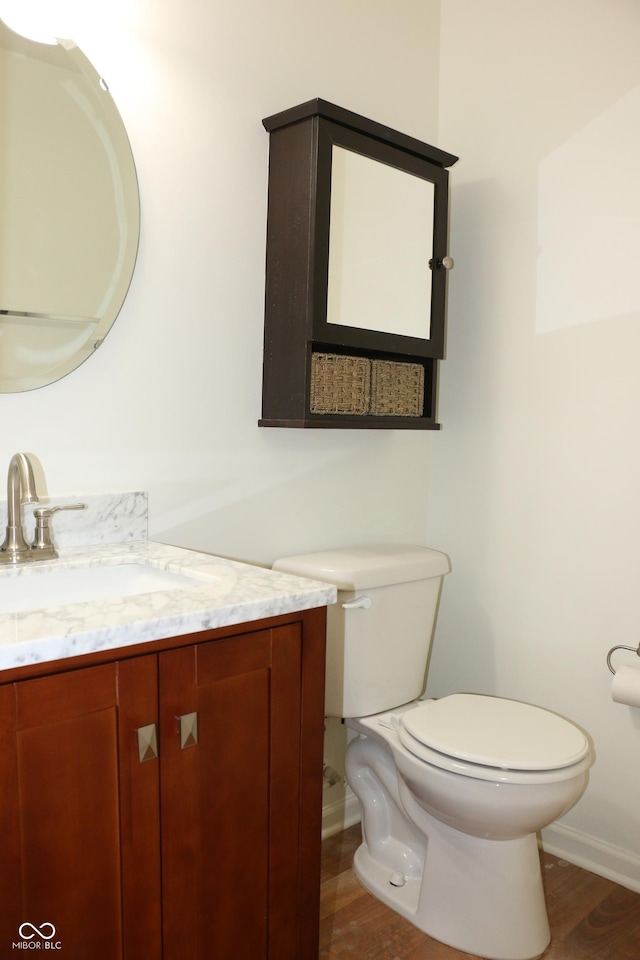 bathroom with vanity, hardwood / wood-style flooring, and toilet