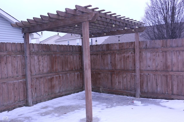 snow covered patio with a pergola