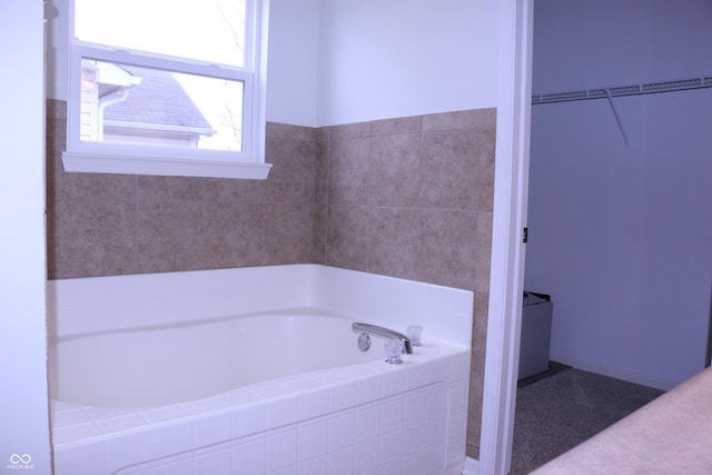 bathroom featuring a relaxing tiled tub