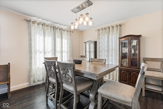 dining space with an inviting chandelier and dark wood-type flooring