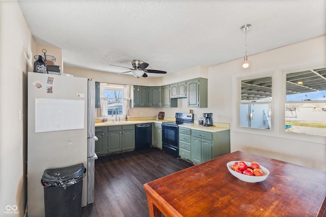 kitchen with sink, a textured ceiling, dark hardwood / wood-style flooring, ceiling fan, and black appliances