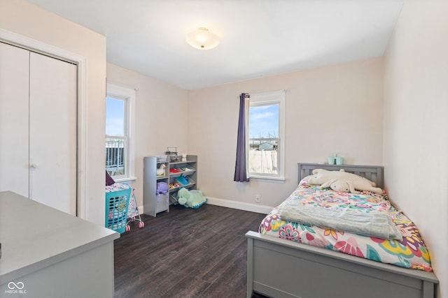 bedroom featuring dark hardwood / wood-style floors and a closet