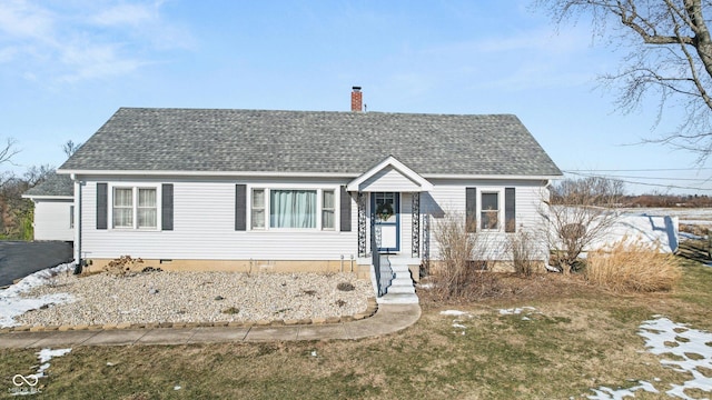 bungalow-style home with a front yard