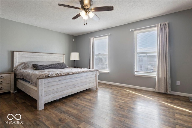 bedroom with ceiling fan, a textured ceiling, and dark hardwood / wood-style flooring