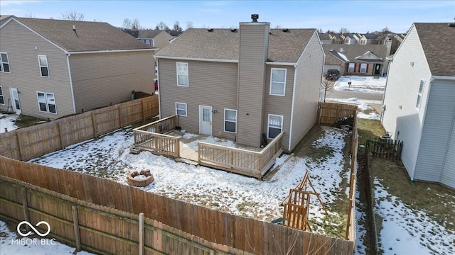 snow covered property with a wooden deck