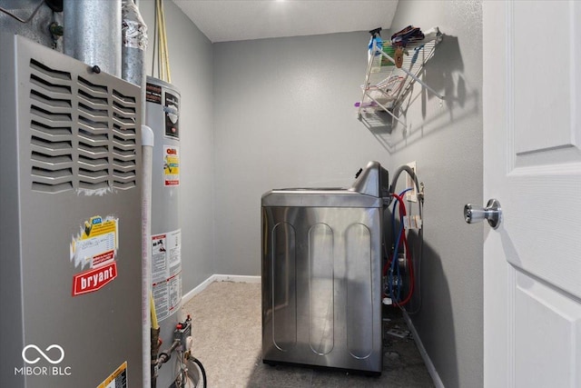 laundry room featuring washer / clothes dryer, water heater, and carpet flooring