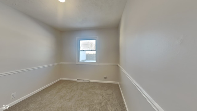 unfurnished room featuring light carpet