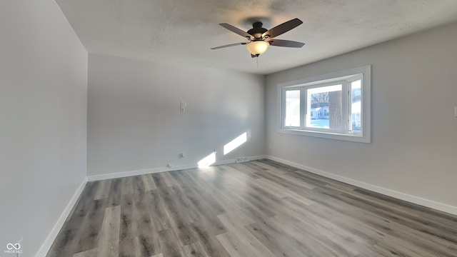 spare room featuring hardwood / wood-style floors, a textured ceiling, and ceiling fan