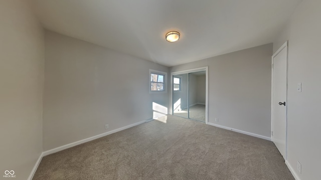 unfurnished bedroom with a closet and carpet flooring