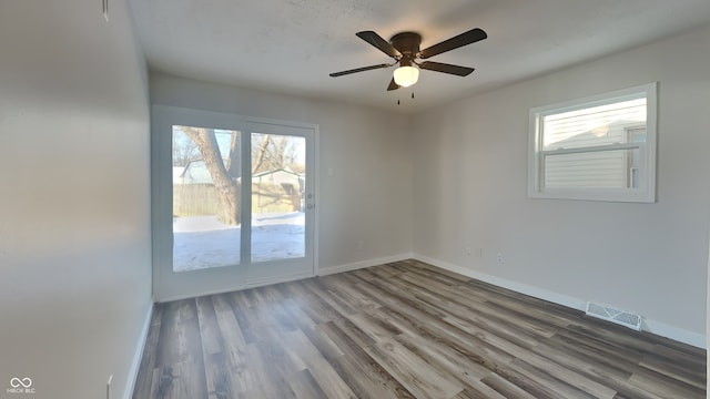 unfurnished room with hardwood / wood-style flooring and ceiling fan