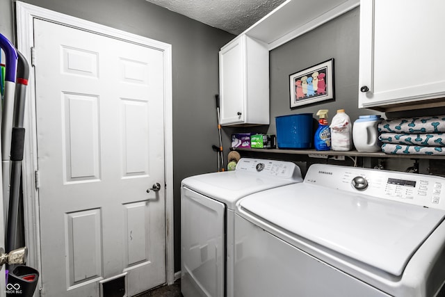 laundry area featuring cabinets, washer and dryer, and a textured ceiling