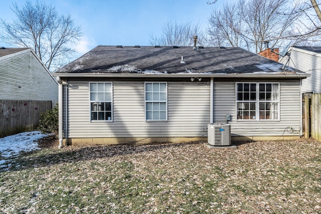 back of property featuring a yard and central AC unit