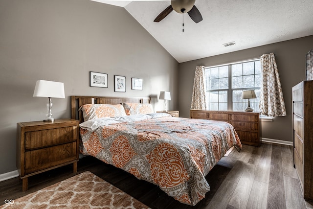 bedroom featuring ceiling fan, dark hardwood / wood-style flooring, high vaulted ceiling, and a textured ceiling