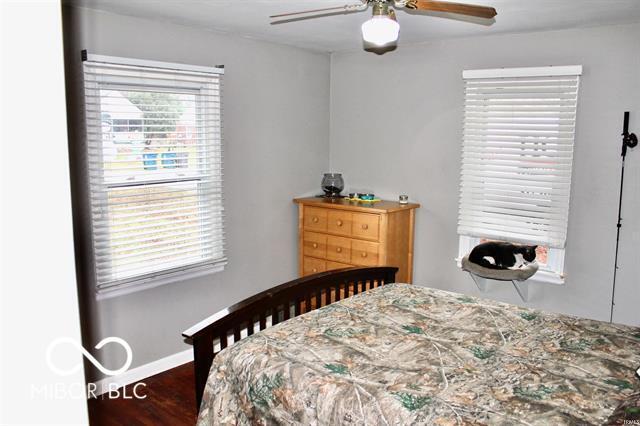 bedroom featuring ceiling fan and dark wood-type flooring