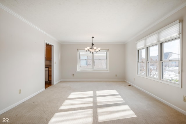 carpeted empty room featuring ornamental molding and an inviting chandelier