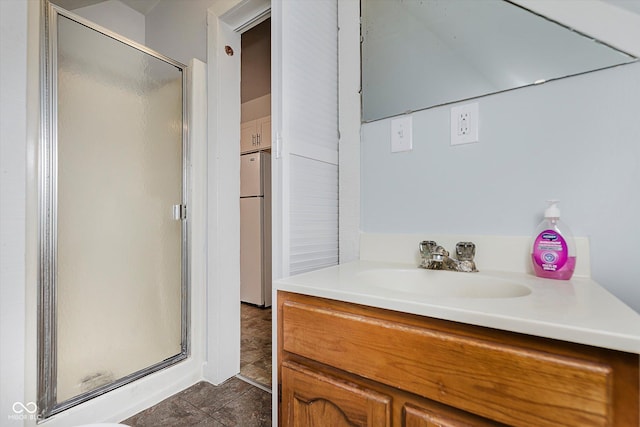 bathroom with a stall shower and vanity