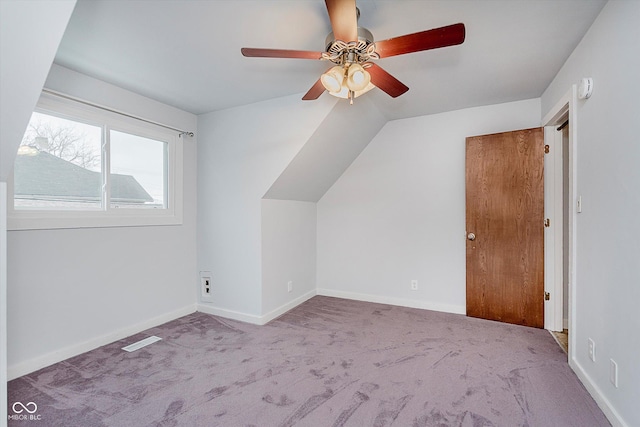 additional living space featuring lofted ceiling, light carpet, and ceiling fan