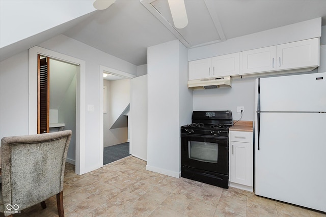 kitchen featuring white cabinets, under cabinet range hood, freestanding refrigerator, and black gas range oven