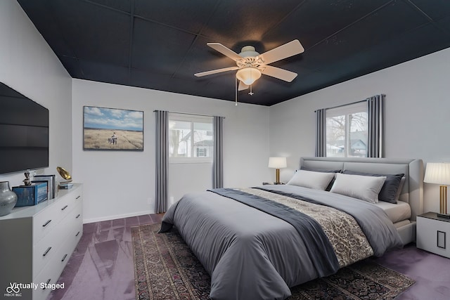 bedroom featuring multiple windows, ceiling fan, and baseboards