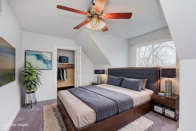 carpeted bedroom featuring lofted ceiling, ceiling fan, baseboards, a spacious closet, and a closet