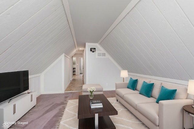 carpeted living room with vaulted ceiling