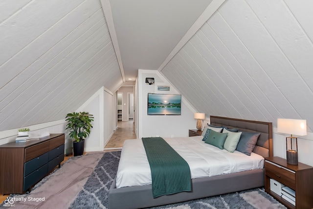 bedroom featuring lofted ceiling and carpet flooring