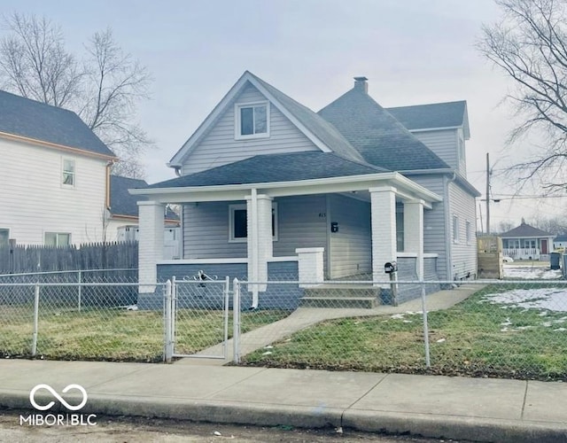 bungalow-style house with a fenced front yard, a gate, covered porch, and roof with shingles