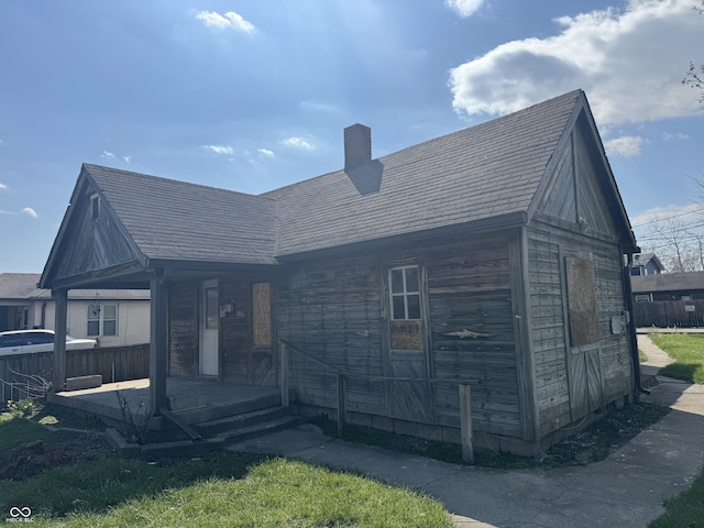 rear view of house featuring a porch