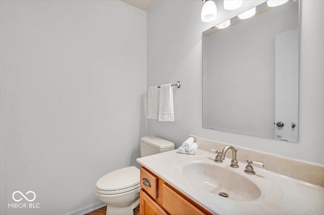 half bath featuring toilet and vanity