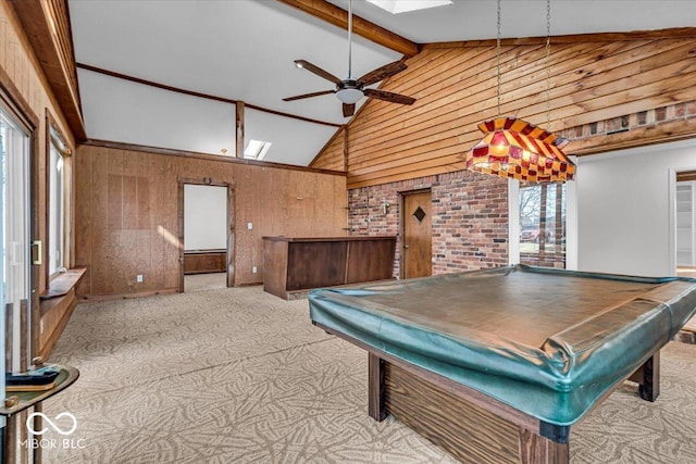 playroom with billiards, a ceiling fan, beam ceiling, a skylight, and wood walls