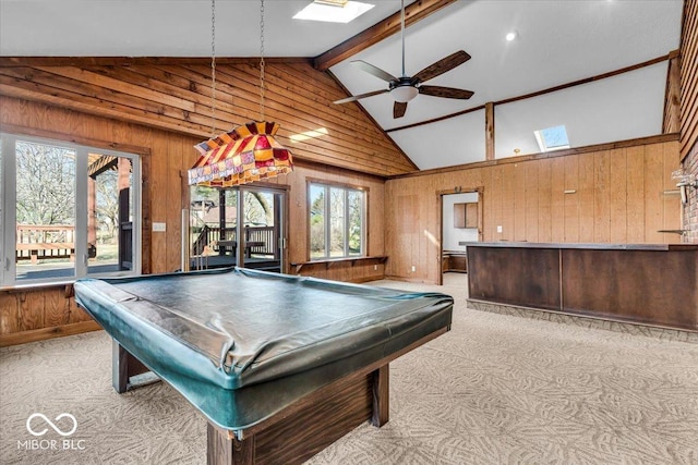 playroom featuring pool table, ceiling fan, light colored carpet, wood walls, and a skylight