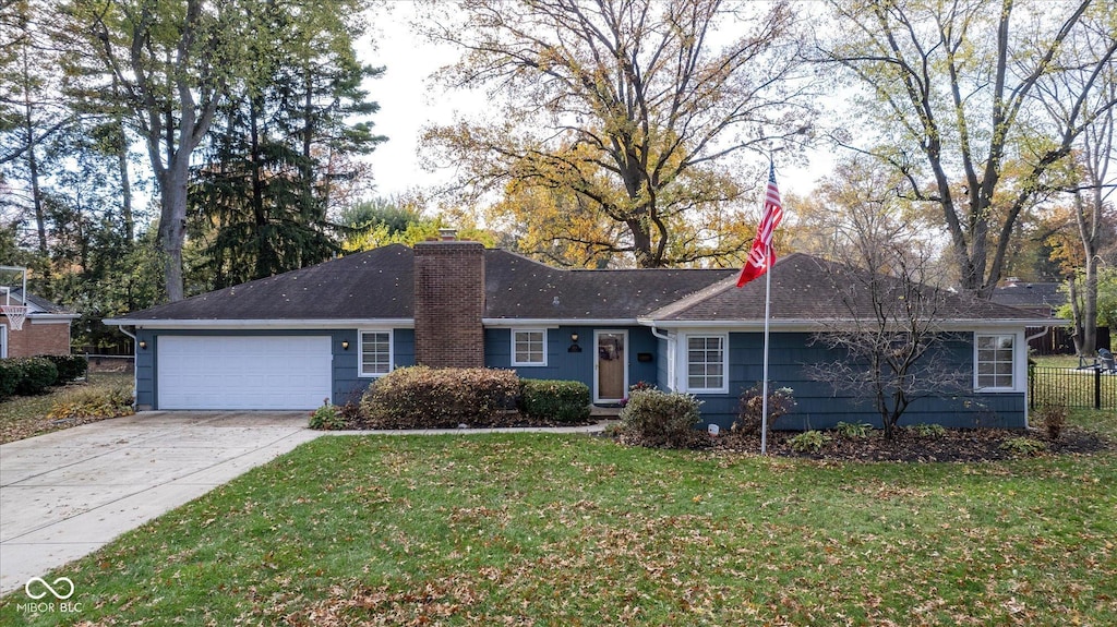 ranch-style home featuring a garage and a front lawn