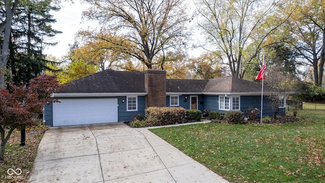 ranch-style house with a garage and a front lawn