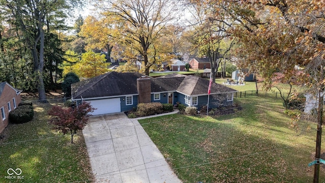 view of front of house featuring a garage and a front lawn