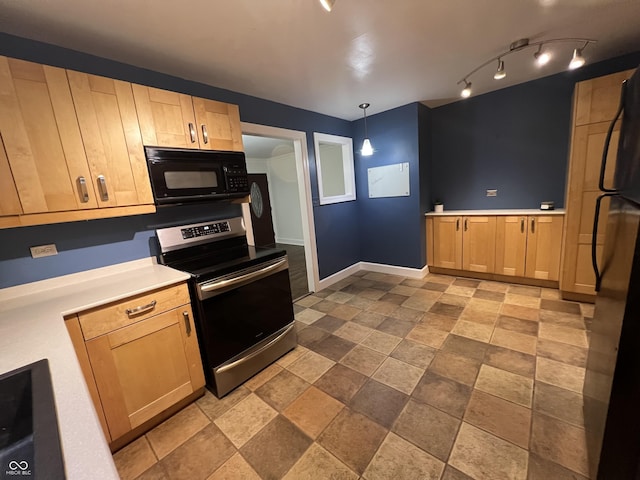 kitchen featuring baseboards, light countertops, light brown cabinetry, black appliances, and pendant lighting