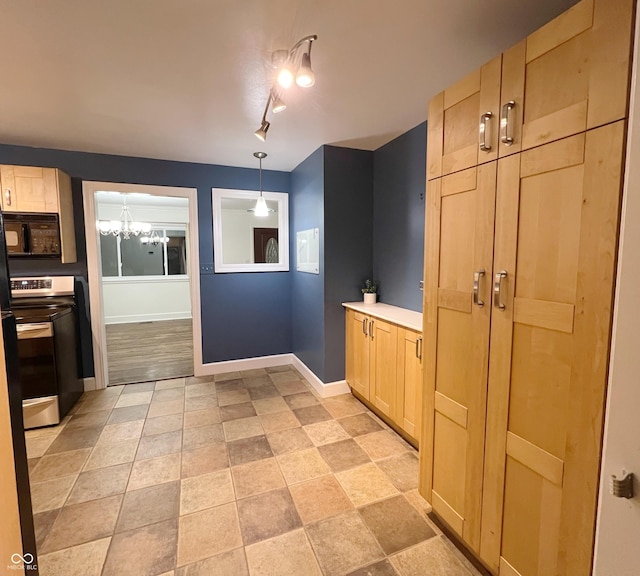 kitchen with black microwave, light brown cabinetry, electric range, and baseboards