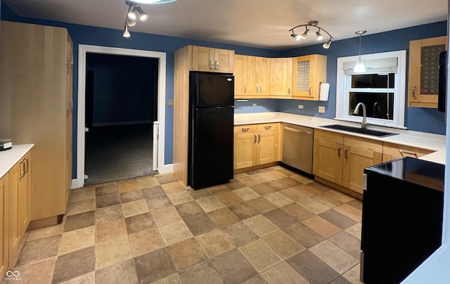 kitchen with light brown cabinets, a sink, light countertops, stainless steel dishwasher, and freestanding refrigerator