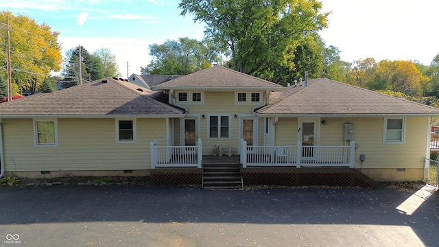 view of front of property featuring crawl space and roof with shingles