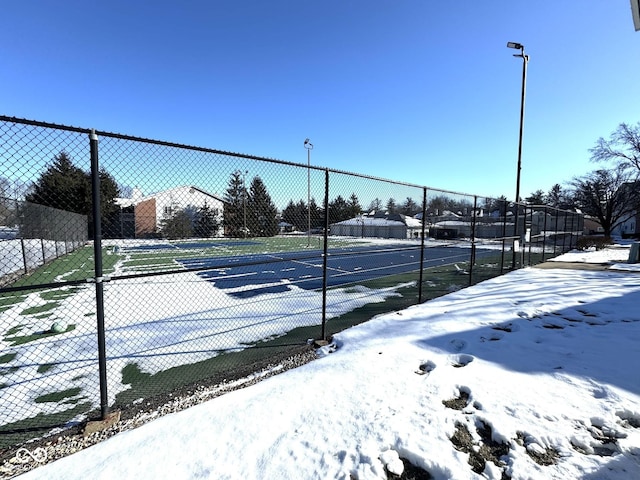 view of tennis court with fence