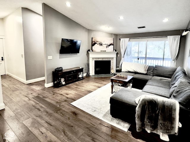 living room with hardwood / wood-style flooring and lofted ceiling