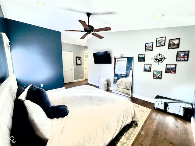 bedroom with vaulted ceiling, dark wood-type flooring, and ceiling fan