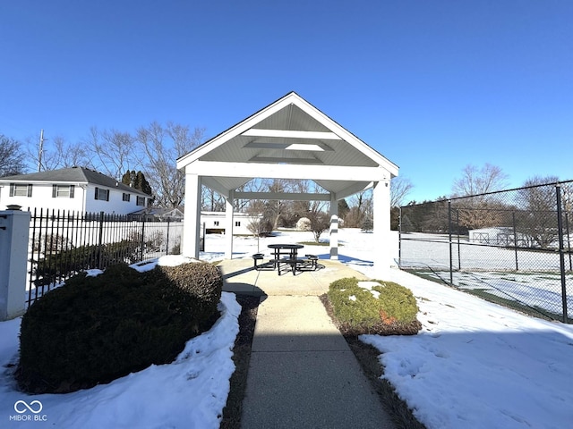 snow covered patio featuring a gazebo and fence private yard