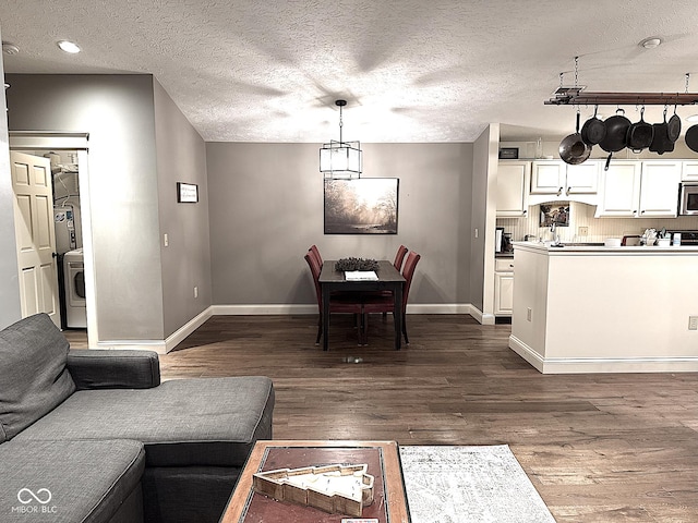 dining room featuring dark wood-style floors, recessed lighting, a textured ceiling, and baseboards