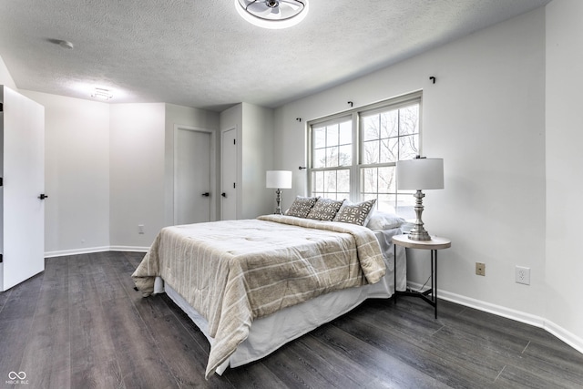 bedroom featuring dark hardwood / wood-style floors and a textured ceiling