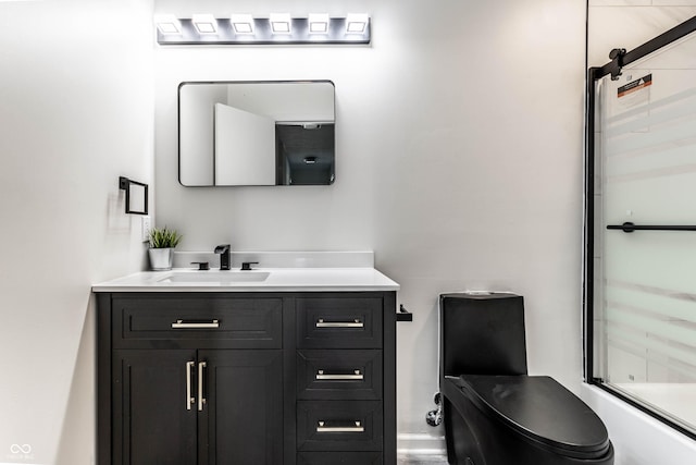 full bathroom featuring vanity, toilet, and combined bath / shower with glass door