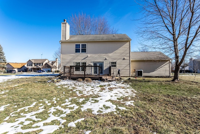 back of house featuring a yard, central AC, and a deck