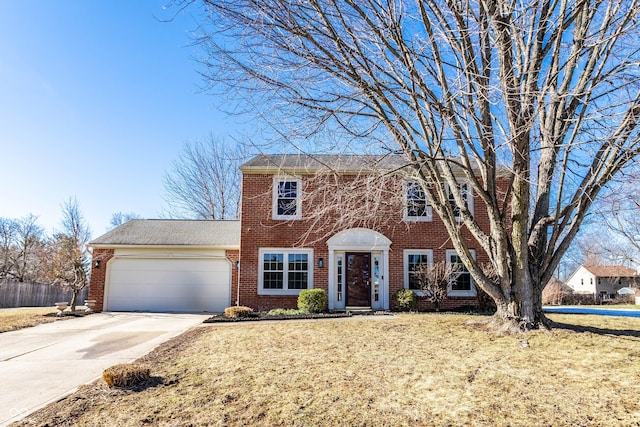 view of front of property featuring a garage and a front lawn