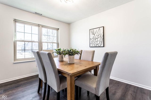 dining area with dark hardwood / wood-style floors