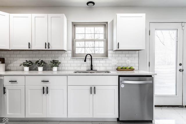 kitchen featuring sink, backsplash, white cabinets, and dishwasher